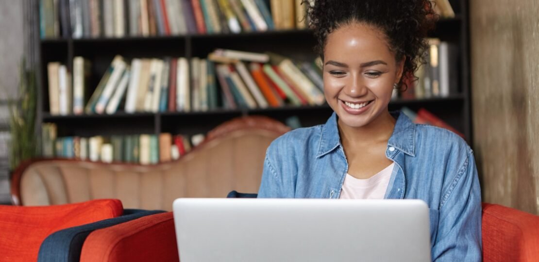 woman-sitting-library-with-her-laptop